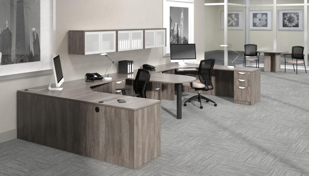 Modern office with grey furniture including desks, chairs, storage units, and a meeting table.=