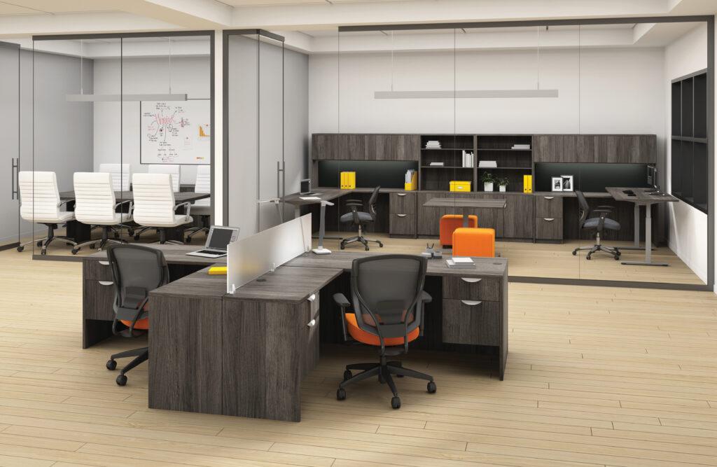 Office space with contemporary grey desks, ergonomic chairs, and storage units.